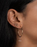 gold classic hoop earrings on model in 30mm size