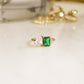 side profile of an emerald ring in gold, showcasing the details of this toi et moi ring