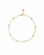 Bezel Set Station Anklet in gold finish, with round bezel-set stones, lobster clasp and heart-shaped end tag.