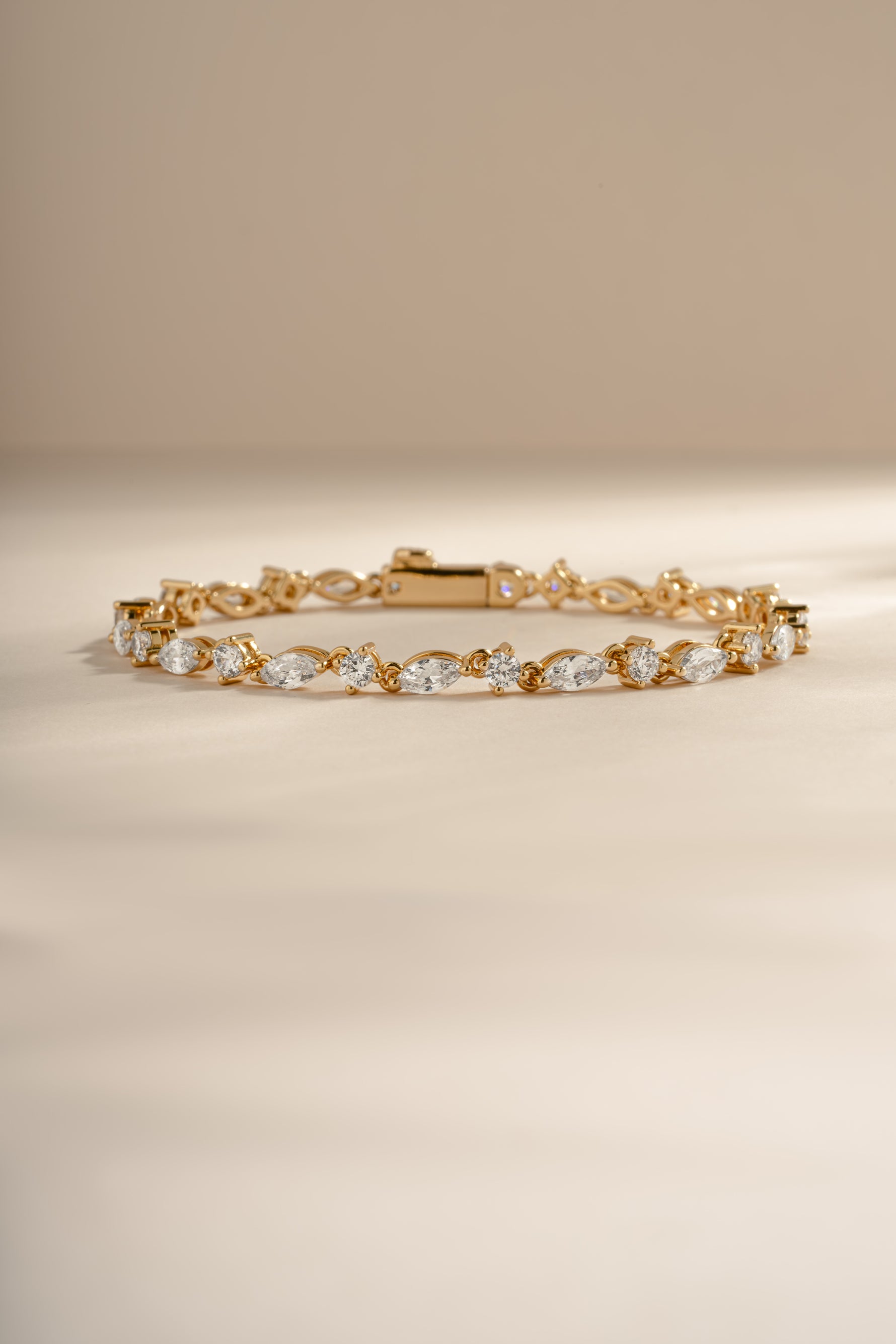 Gold dainty bracelet with marquise and round diamond stones, elegant jewelry piece by Sami Jewels