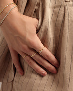 gold diamond baguette ring stack on models hand