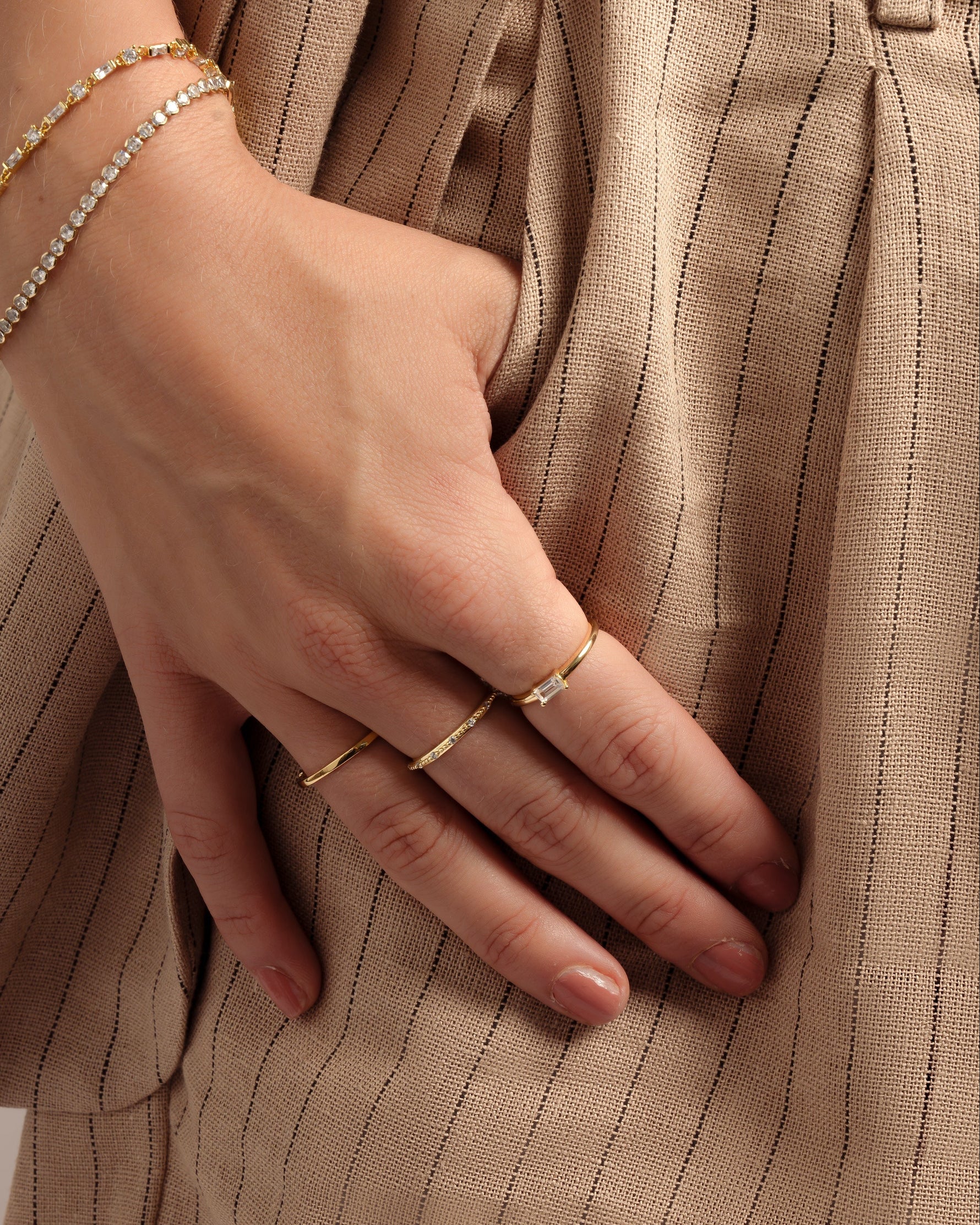 gold diamond baguette ring stack on models hand