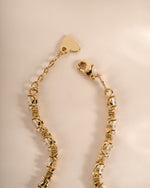 Gold tennis bracelet with white cubic zirconia stones adjustable clasp. 