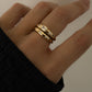 Gold dome starburst stacking rings on model, stacked with other tiny starburst ring in 14k gold plated. 