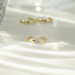 gold ear cuff with diamond center stone