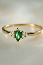 gold diamond emerald marquise ring closeup