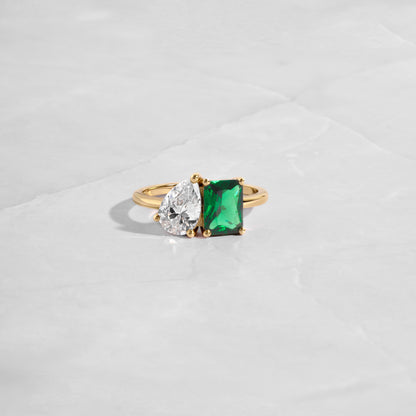 Close-up of the Toi et Moi Ring focusing on the emerald cut and pear stone. 