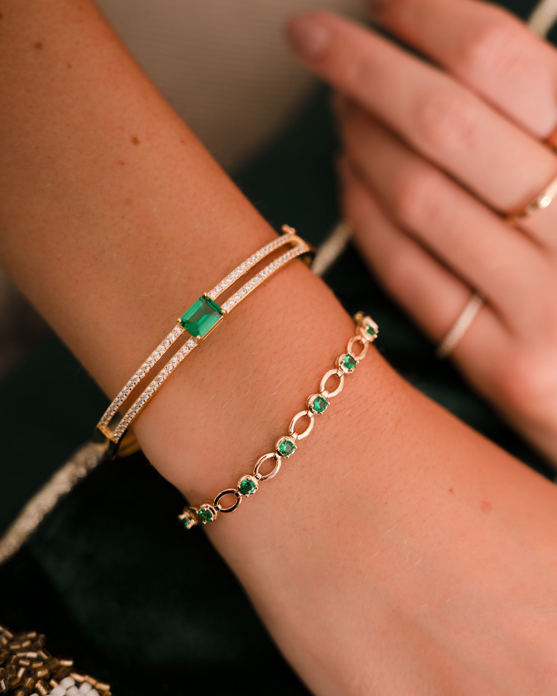 gold emerald tennis bracelet on model
