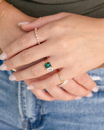 gold emerald toi et moi diamond ring stack on models hand