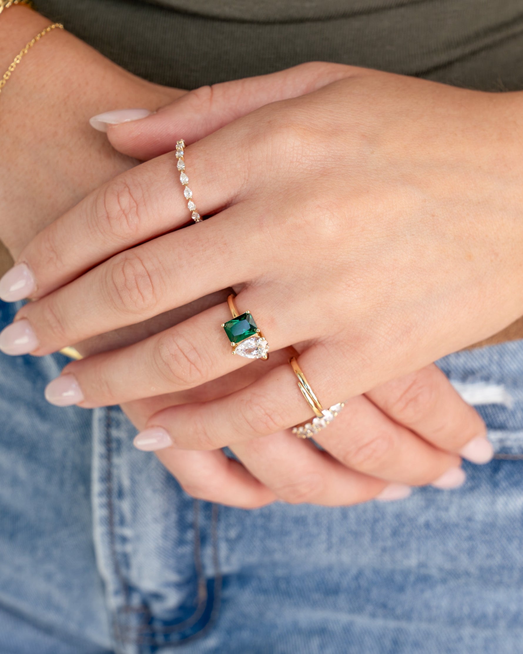 gold emerald toi et moi diamond ring stack on models hand