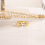 flat lay of a statement ring in its own quiet way, the fluted details add a vintage-inspired touch to the gold ring, perfect as an engagement ring or promise ring.