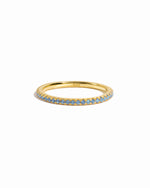 gold blue topaz eternity ring white background 