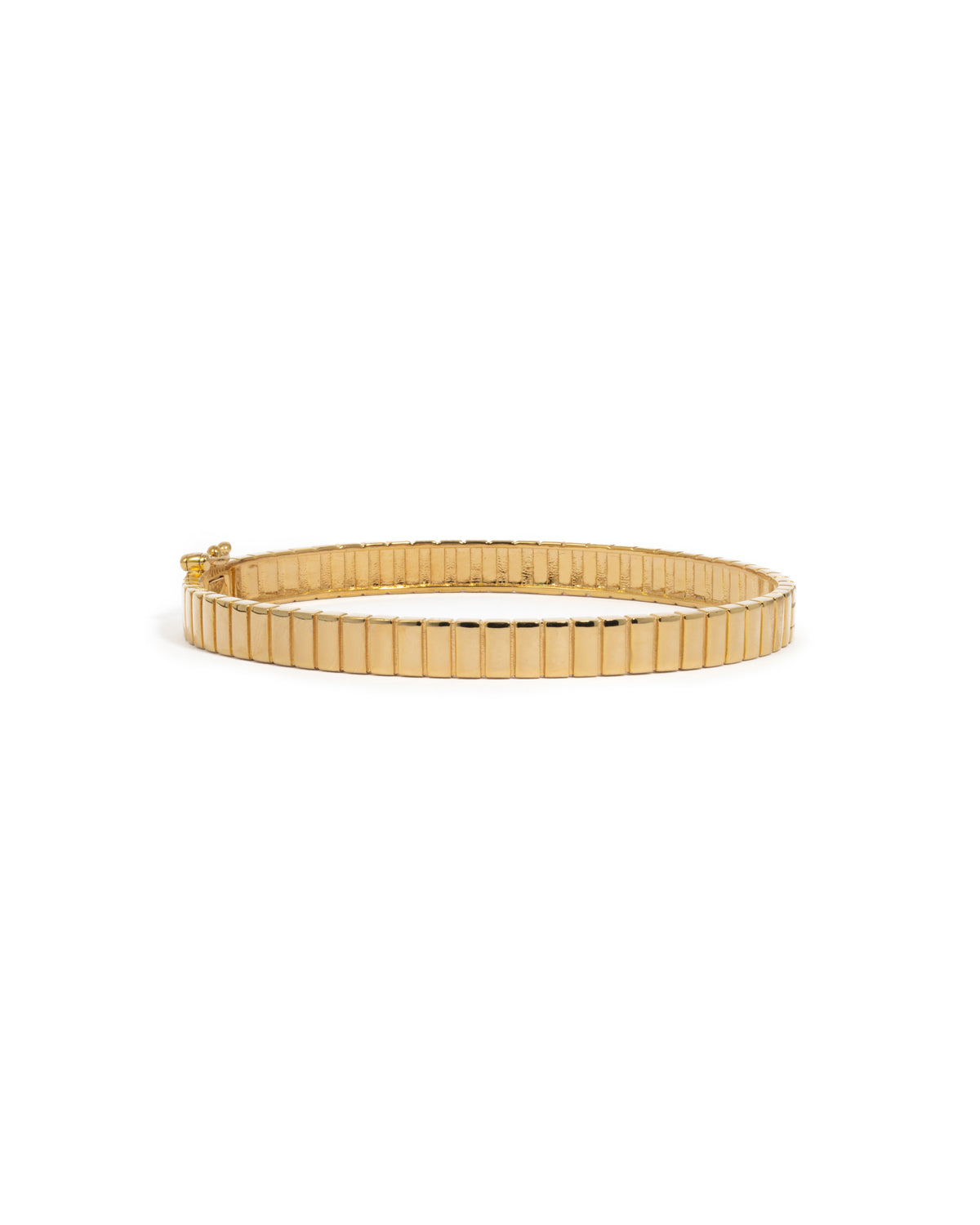 Gold fluted bangle bracelet on a white background.