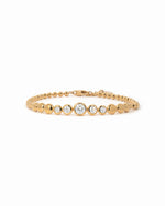 Gold graduated bezel tennis bracelet with clear cubic zirconia on a white background.