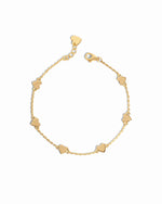 Flat-lay of the love bracelet, highlighting its delicate gold finish and heart charm details.