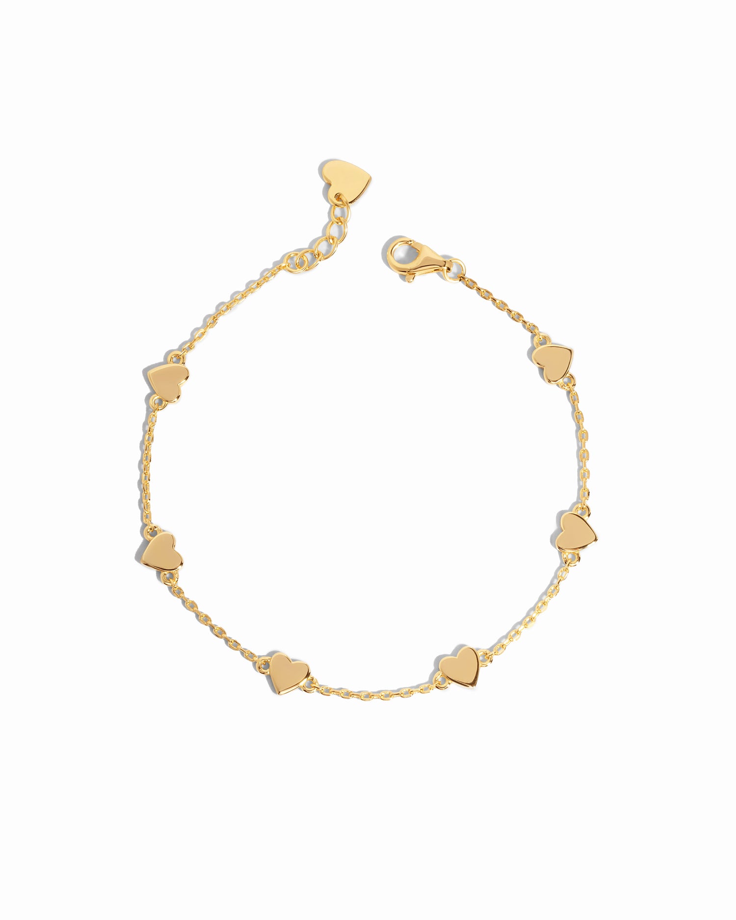 Flat-lay of the love bracelet, highlighting its delicate gold finish and heart charm details.