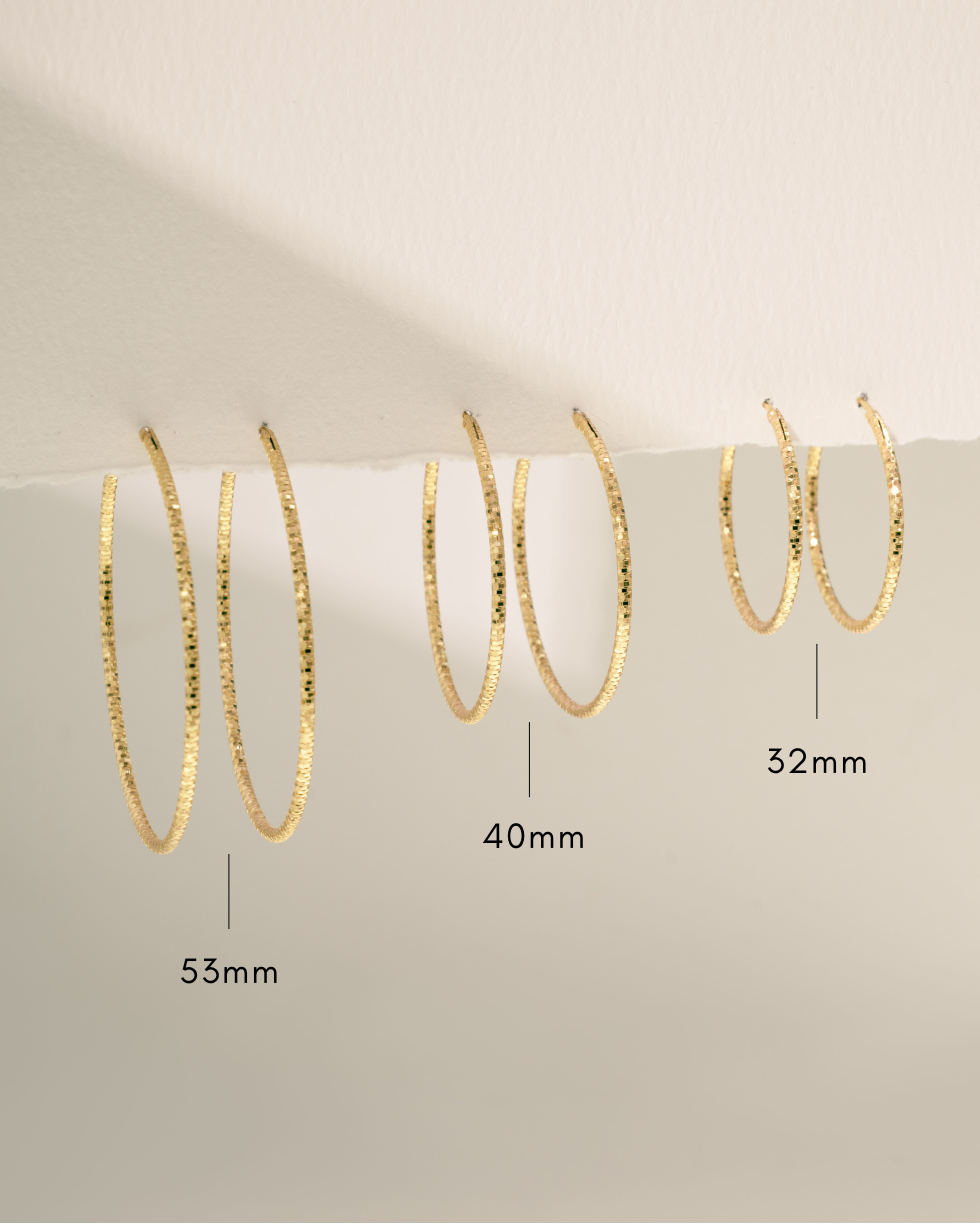 gold hoop earring sizing infographic on neutral background 