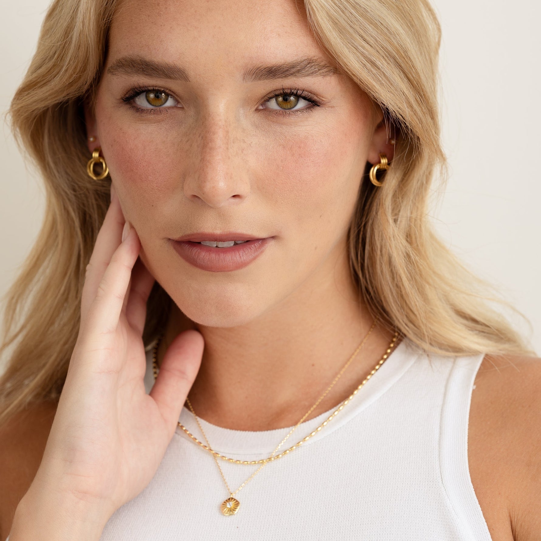 model wearing gold jewelry