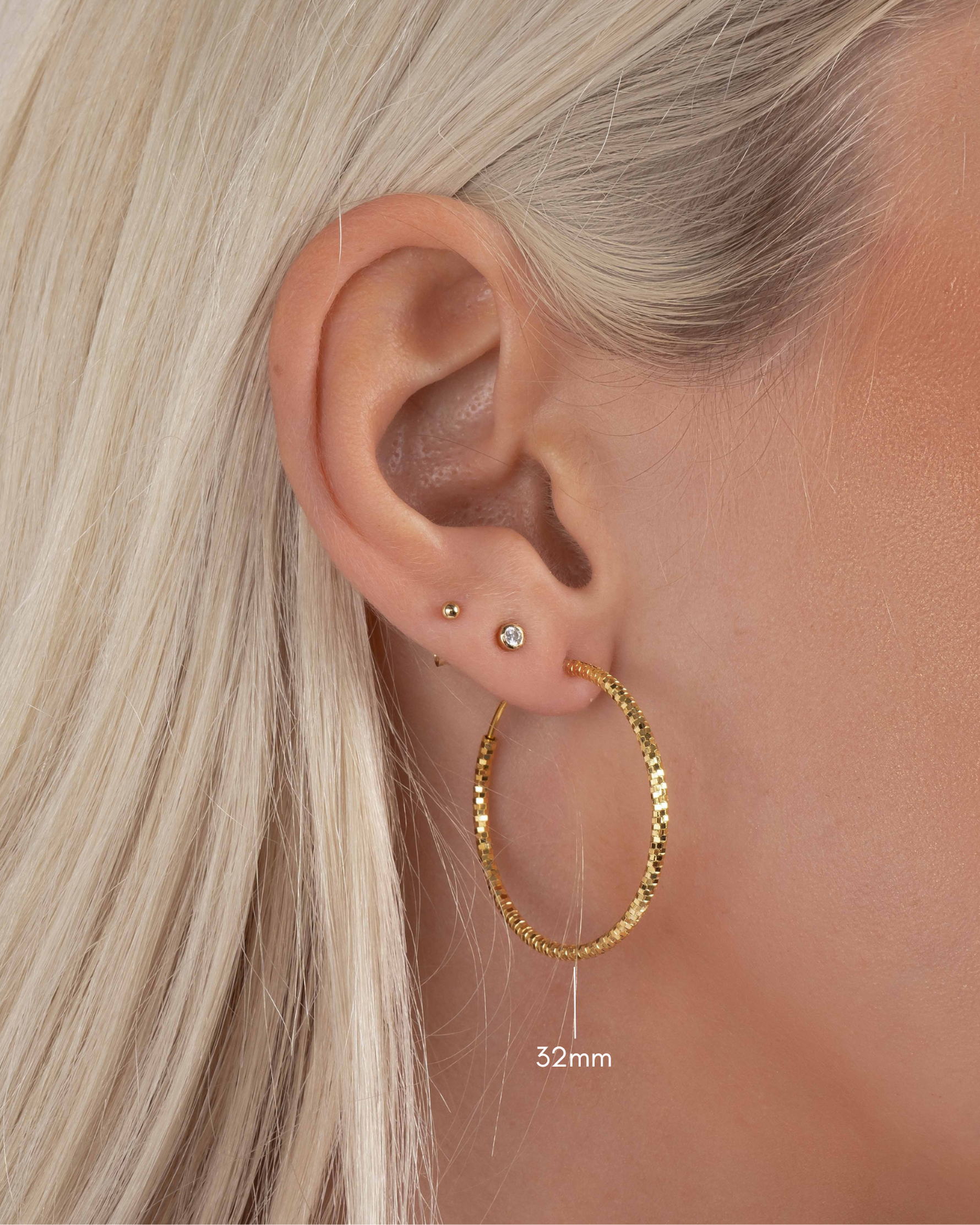 gold hoop earrings on model in 32mm size