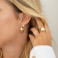 gold chunky hoop earrings on model 