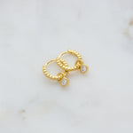 Gold beaded huggie hoops with bezel charm. 