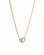 Gold interlocking circle necklace with a small pendant on a white background