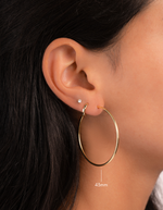 gold 43mm infinity hoop earrings on model