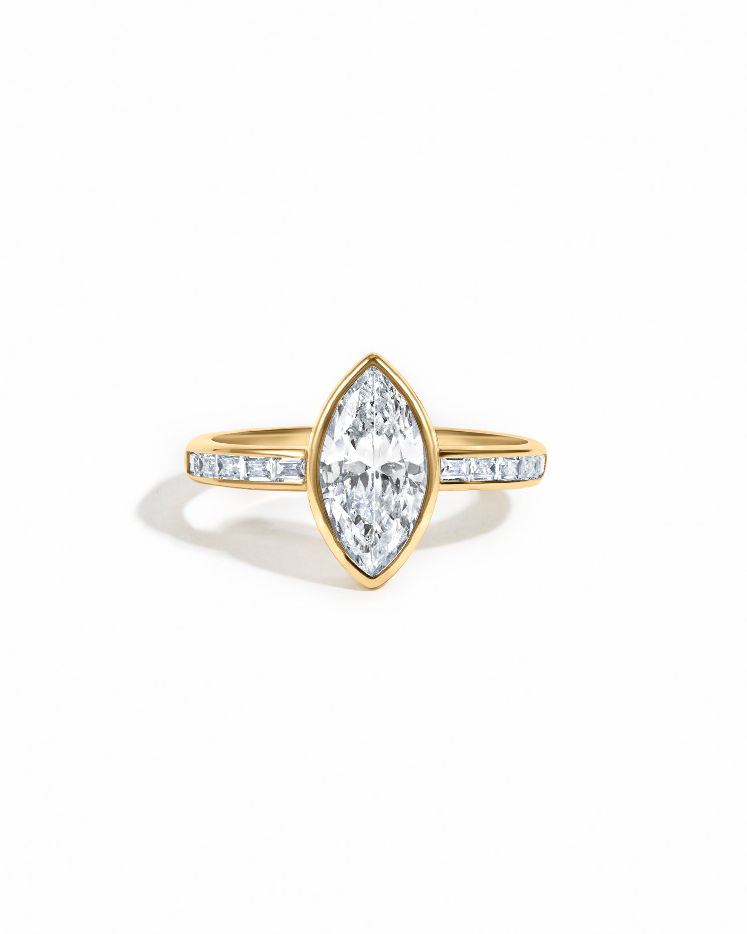 Gold Marquise Bezel Ring with Baguette Band from Sami Jewels, showcasing an elegant design with marquise and baguette cut accents.