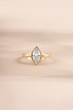 Gold Bezel Marquise Ring by Sami Jewels featuring a large marquise-shaped cubic zirconia gemstone.