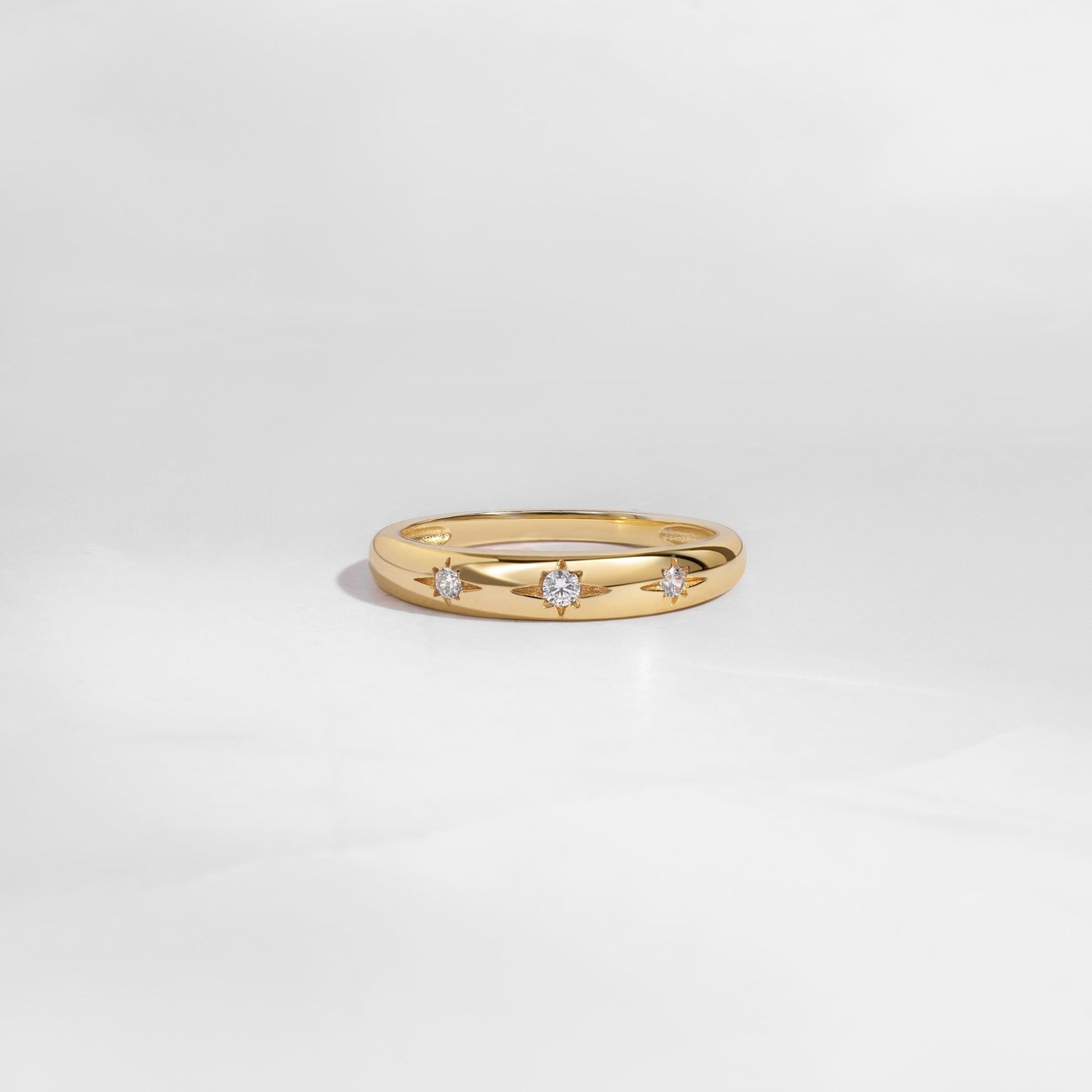 Gold minimalist Diamond Ring with Star Setting on white background