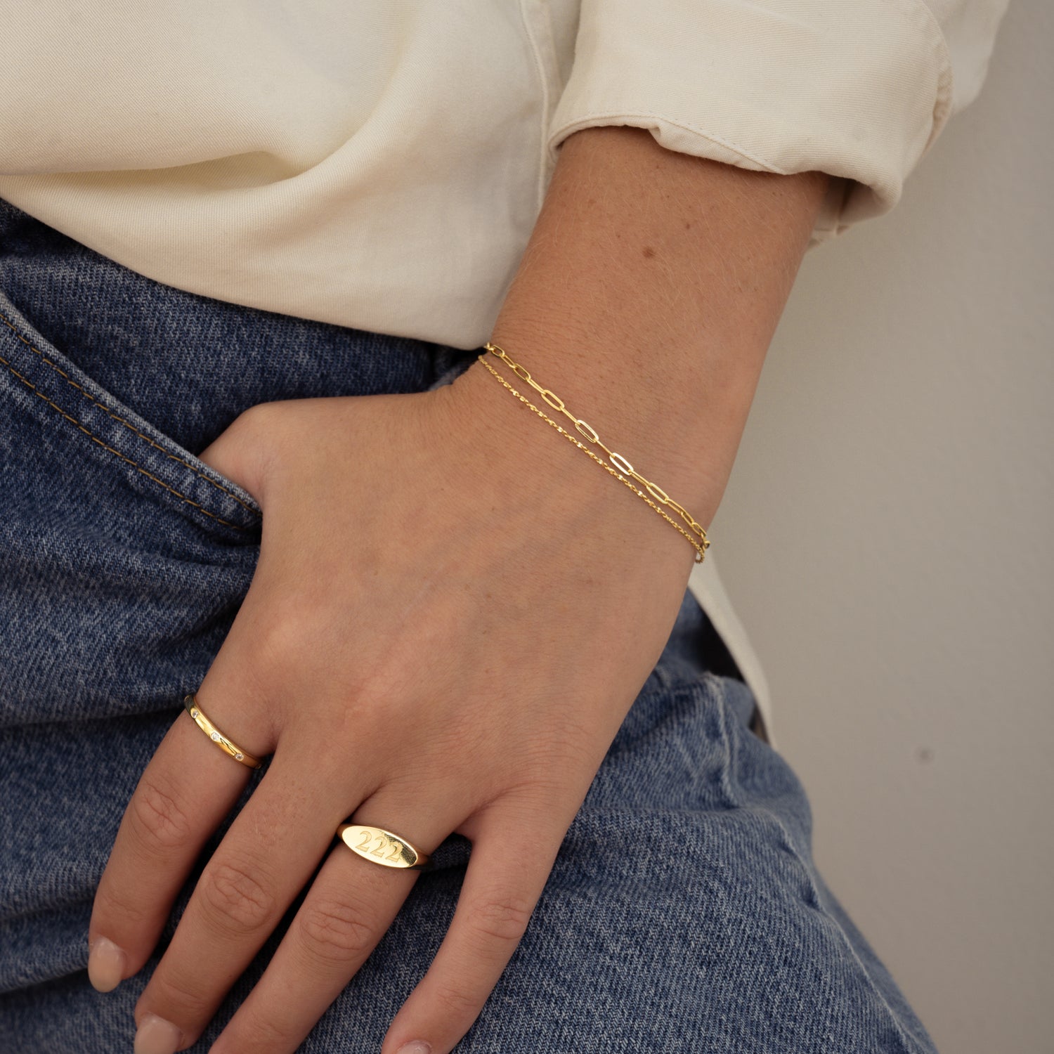 model wearing dainty gold bracelet set