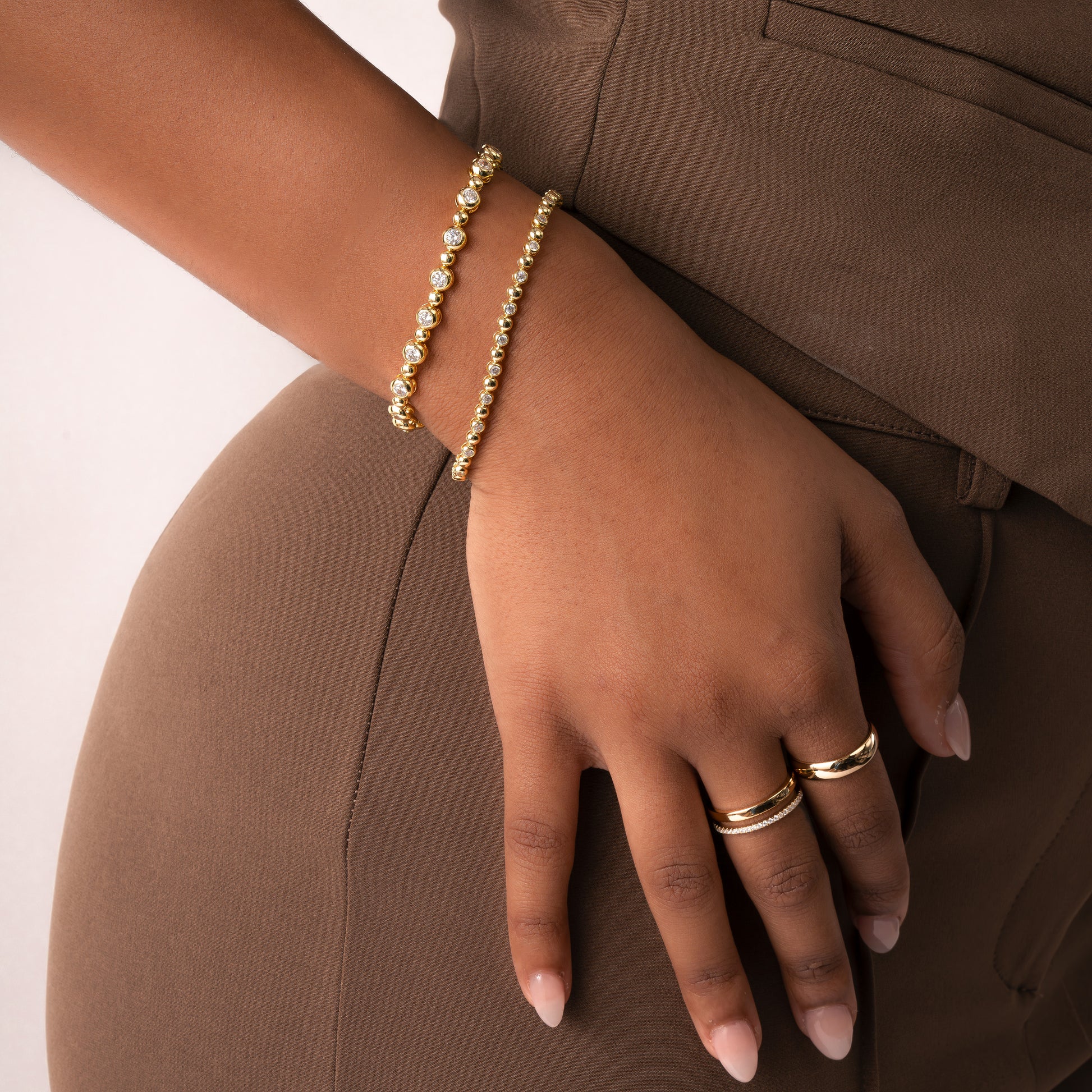 Gemstone gold minimalist ladies bracelet worn on model wearing other dainty gold diamond rings