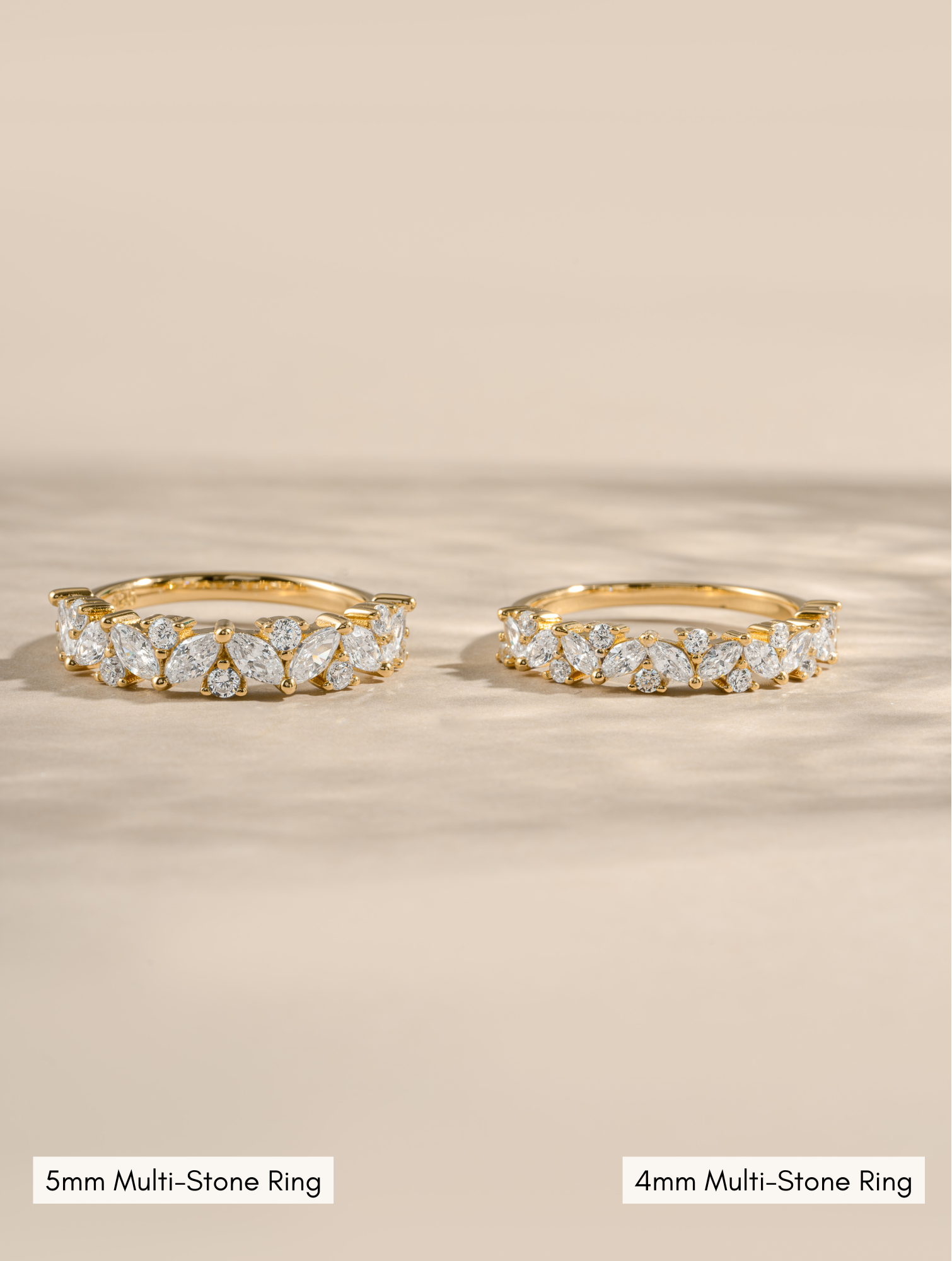 5mm gold multistone ring compared to a 4mm gold multi stone ring on a neutral background