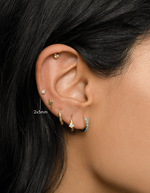 gold pear stud earring stacked on womens ear 