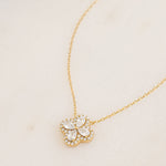 close up of delicate diamond pendant necklace of a four leaf clover made with pear shaped stones in the shape of a four leaf clover