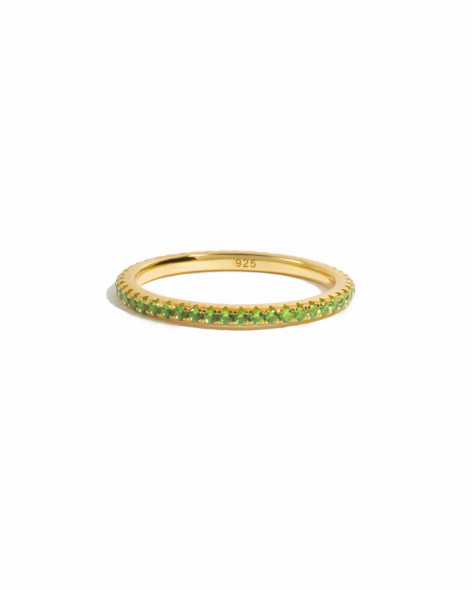 gold peridot birthstone eternity ring white background