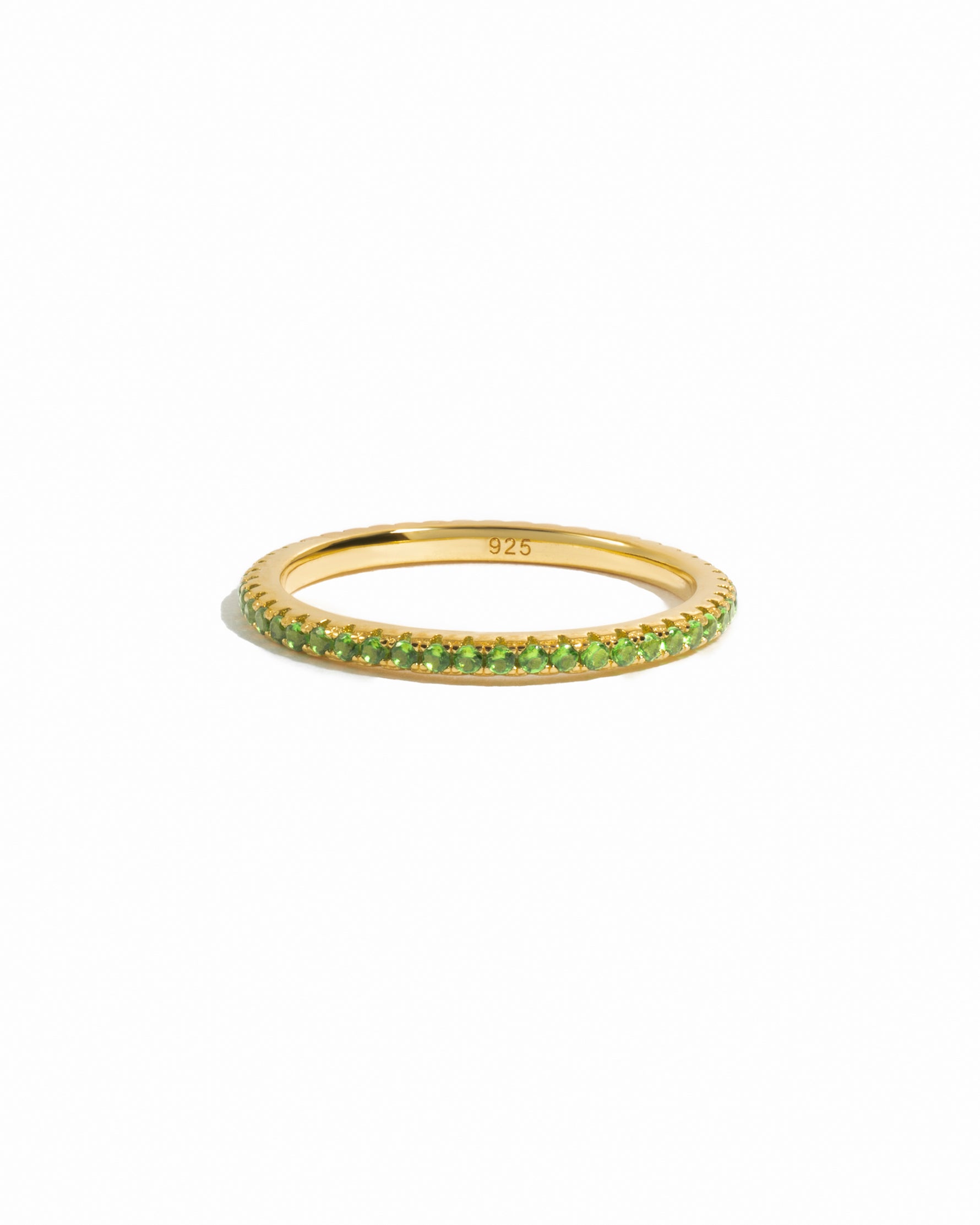 gold peridot birthstone eternity ring white background