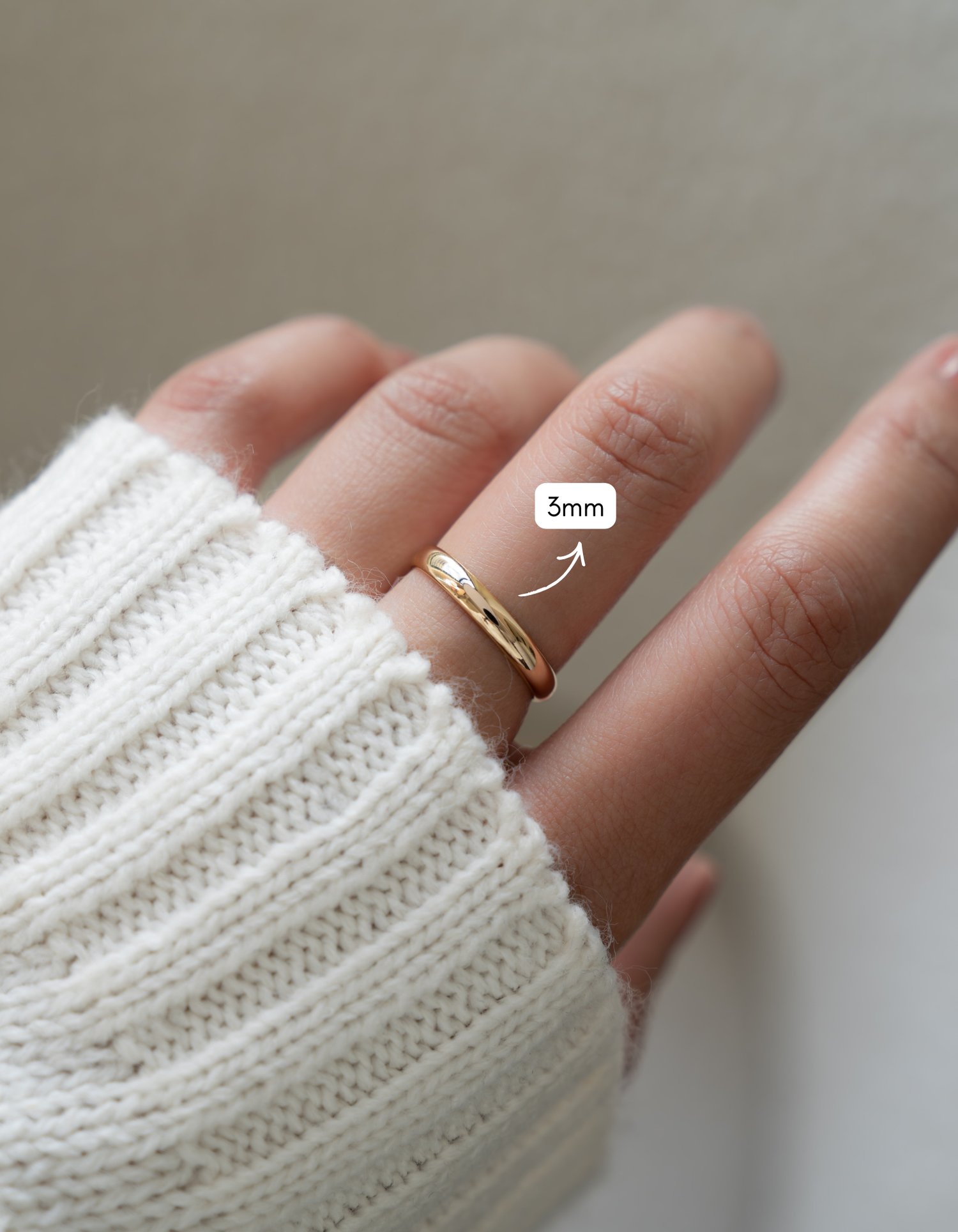 gold 3mm plain band ring on models hand