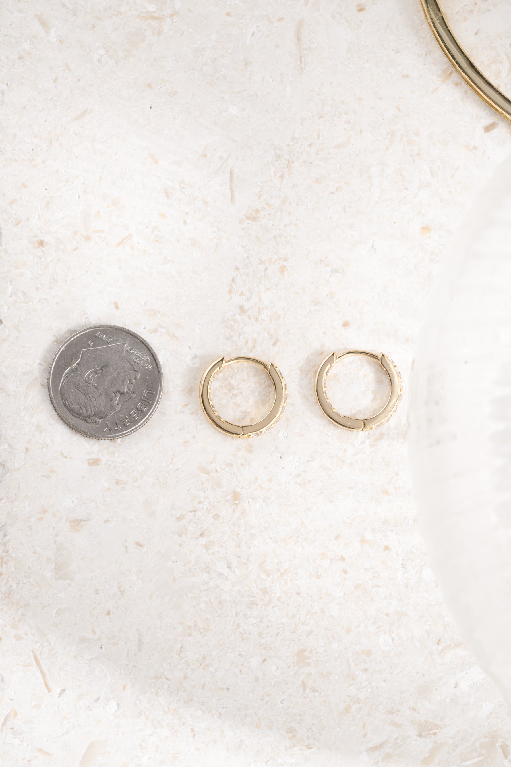 gold plated 10mm diamond studded huggie hoops compared to size of dime 