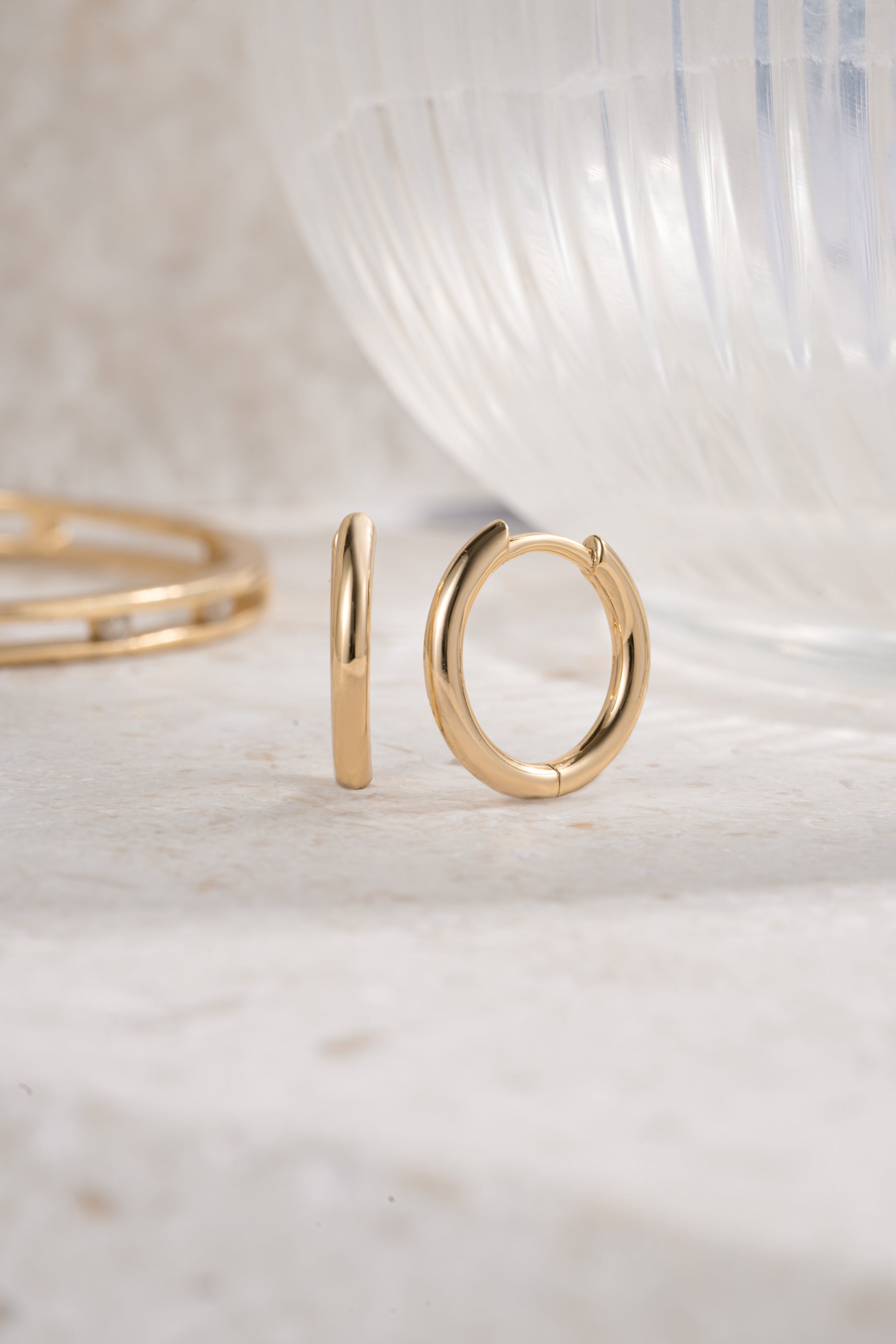 gold 11mm minimalist hoop earrings neutral background