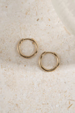 gold 13mm minimalist hoop earrings profile view on a neutral background 