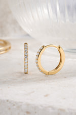 gold plated 13mm diamond studded huggie hoop neutral background