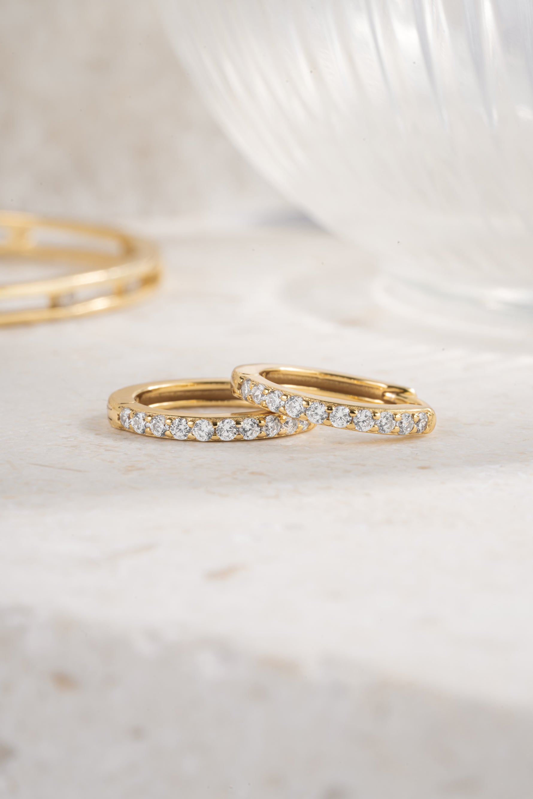 gold plated 13mm studded huggie hoop neutral background