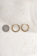 gold plated 16mm studded huggie being compared to a dime size