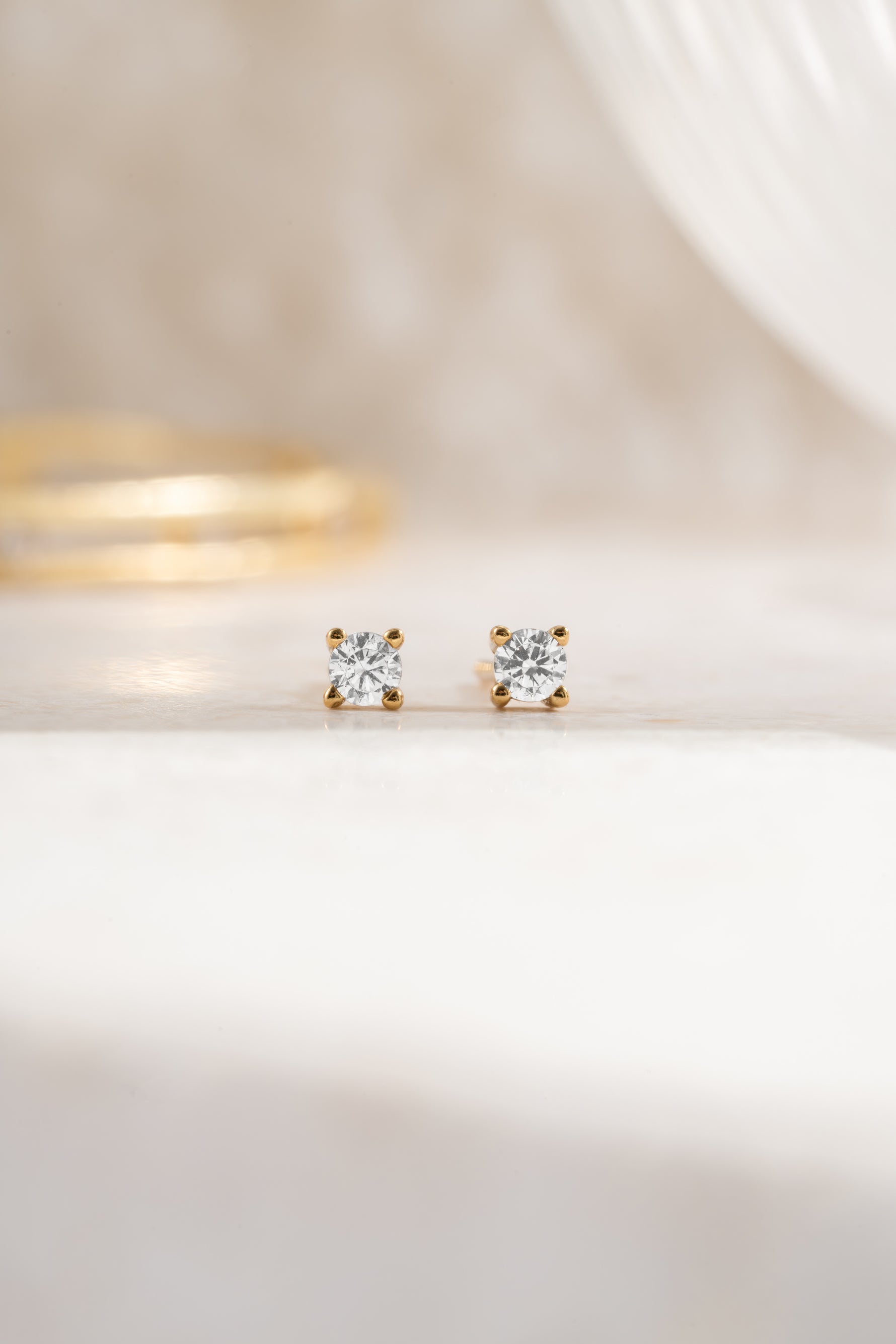 Gold plated 2.5mm diamond solitaire stud earring white background