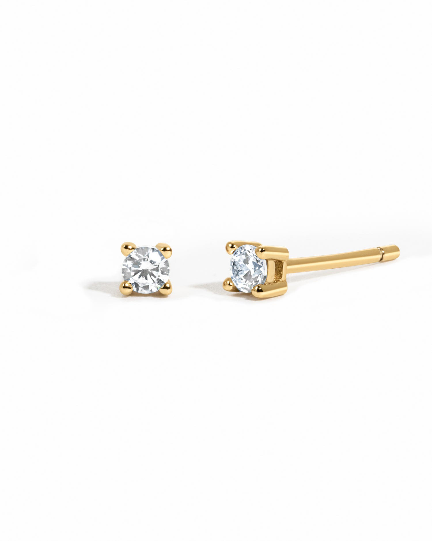 gold plated diamond stud earrings white background