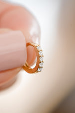 Gold plated 7mm studded huggie earrings with cubic zirconia front view