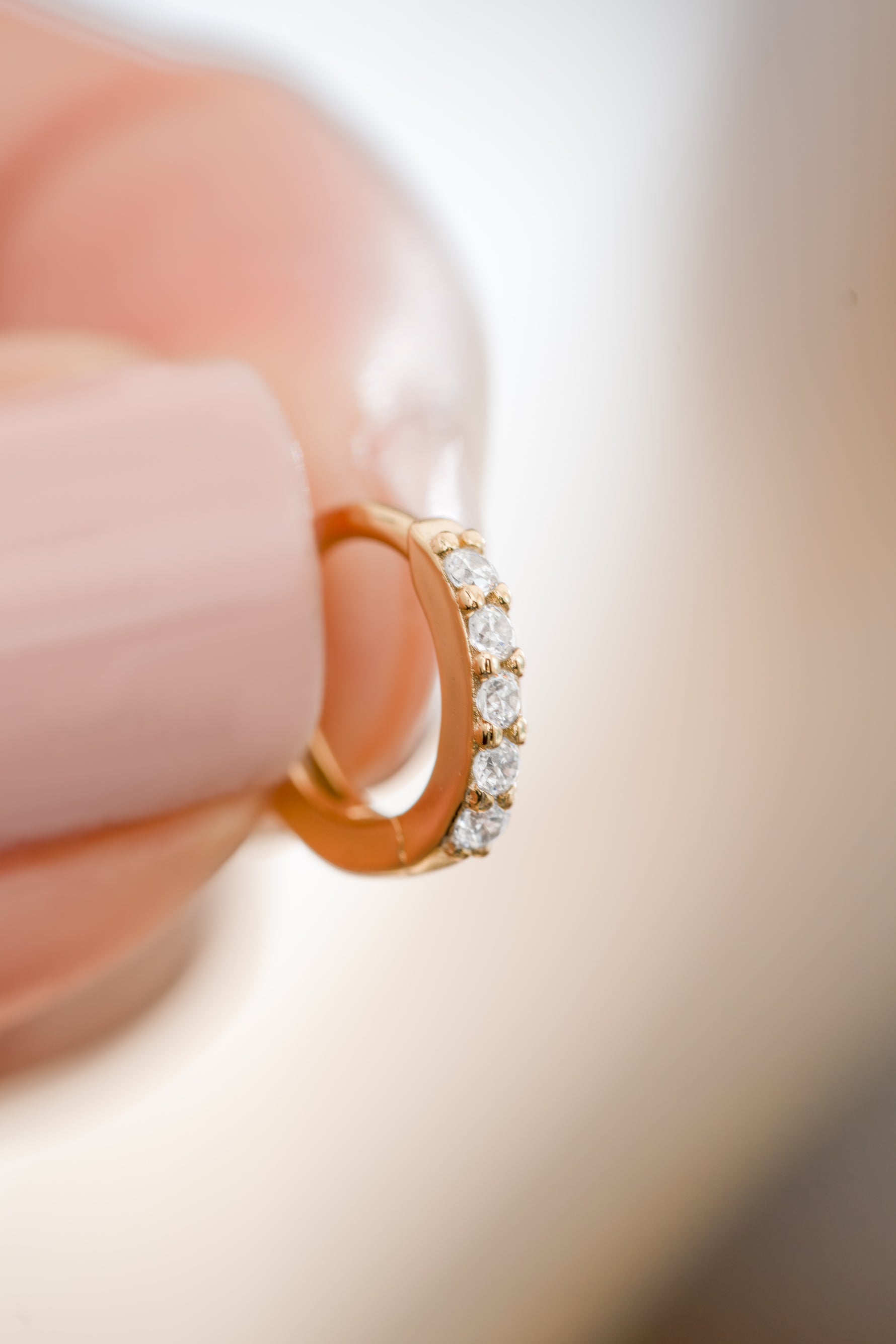 Gold plated 7mm studded huggie earrings with cubic zirconia front view