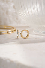 Gold plated 7mm studded huggie earrings with cubic zirconia side view