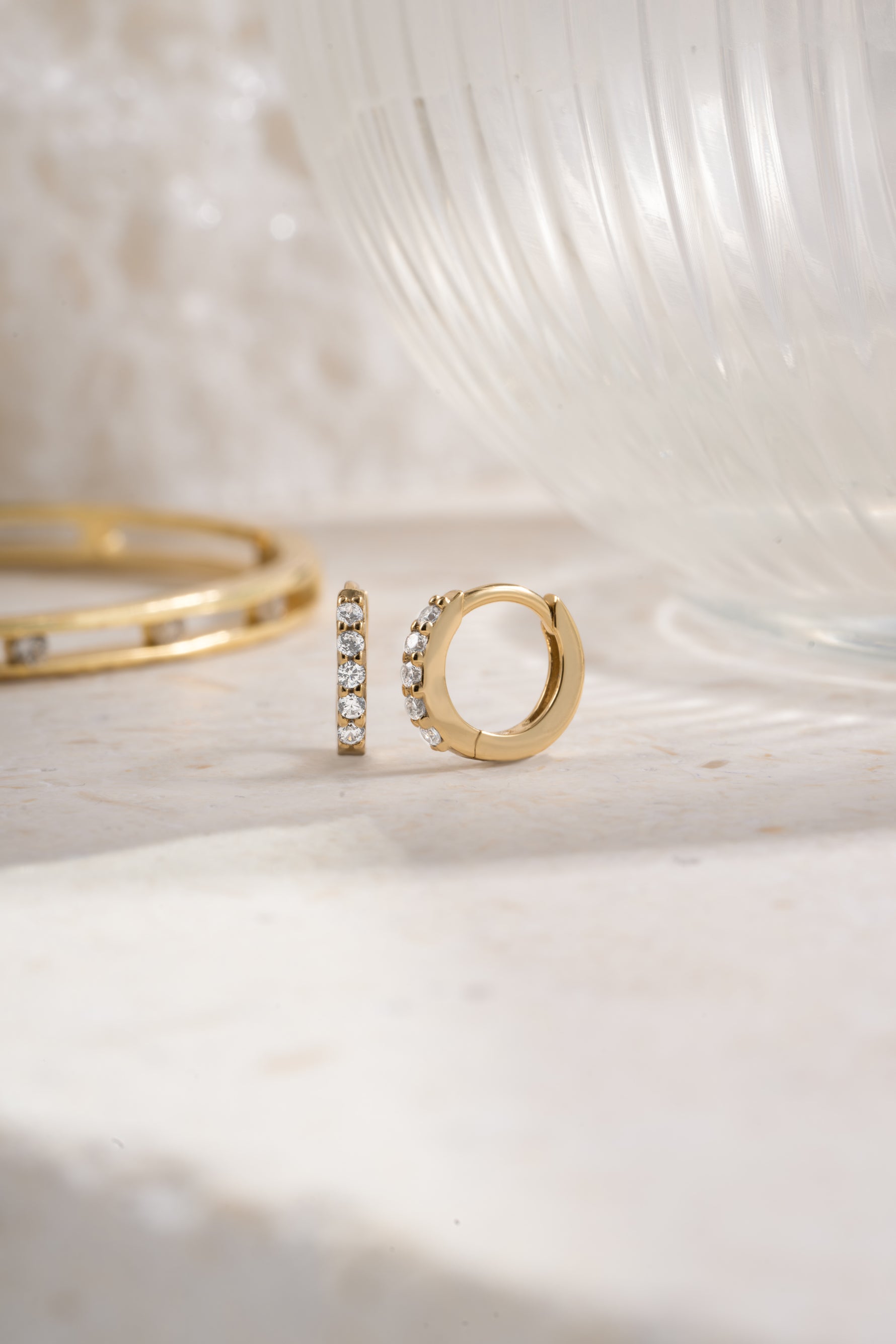 Gold plated 7mm studded huggie earrings with cubic zirconia side view